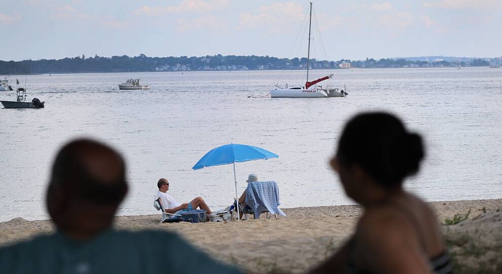 A warm haze settled over sunbathers, boaters and shade-seekers at Carson Beach